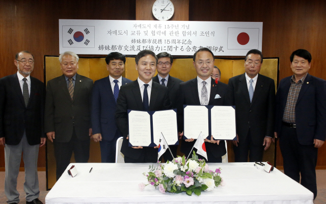 지난 2017년 일본 가나자와시청에서 열린 ‘전주-가나자와시 자매결연 체결 15주년 기념행사’에서 김승수 전주시장과 야마노 유키요시 가나자와시장이 문화교류 확대 협약을 체결하고 기념촬영을 하고 있다. (사진=전주시)